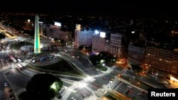 FILE - The Obelisk is lit up in the Brazilian team colors of yellow and green in Buenos Aires, June 10, 2014. The Trump Organization says it has no plans to build in the heart of Argentina's capital.