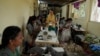 A group of tailors work in a small garage using electric sewing machines at the campus of the Swami Vivekananda Youth Movement, a nongovernmental organization that works to help poor and Indigenous communities, in Kenchanahalli, India, Sept. 23, 2024. 