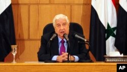 FILE - In this photo released by the Syrian official news agency SANA, Syrian Foreign Minister Walid al-Moallem speaks during a press conference in Damascus, Syria, May 8, 2017.