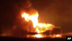 A video image from news station Noticias Ciudad del Carmen shows a fire burning at an oil platform in the Gulf of Mexico along the Mexican coast before sunrise, April 1, 2015.