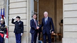 Perdana Menteri Prancis yang baru, Michel Barnier (kana) berjabat tangan dengan pendahulunya Gabriel Attal dalam acara serah terima di Paris pada 5 September 2024. (Foto: Stephane de Sakutin, Pool Photo via AP)