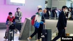 Passengers arrive at LAX from Shanghai, China, after a positive case of the coronavirus was announced in the Orange County suburb of Los Angeles, California, U.S., January 26, 2020.