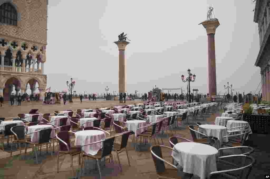 Empty tables sit in St. Mark&#39;s square in Venice, Italy. Italy has been scrambling to check the spread of Europe&#39;s first major outbreak of coronavirus amid rapidly rising numbers of infections. 