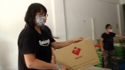 Tan Mei Ling, a piano teacher, helps organize the donated food and PPE being sent to Semporna, Malaysia. (Dave Grunebaum/VOA)