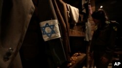 An Israeli woman officer looks at a model of the headquarters bunker of the Jewish Combat Organization (ZOB) Mila 18 in the Warsaw Ghetto at the museum "From Holocaust to Revival" in Kibbutz Yad Mordechai near the coastal town of Ashkelon, Israel, Sunday,