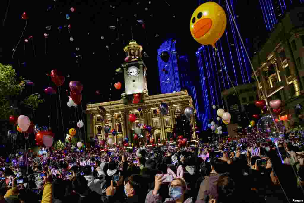 People gather to celebrate the arrival of the new year during the coronavirus disease outbreak in Wuhan, China, Dec. 31, 2020.