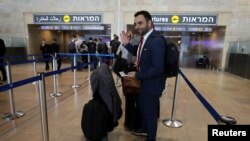 Omar Shakir, a U.S. citizen representing New York-based Human Rights Watch in Israel and the Palestinian territories, waves before departing Israel at Ben Gurion International Airport, near Tel Aviv, Israel, Nov. 25, 2019.