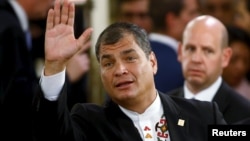 FILE - Ecuador's President Rafael Correa waves as he arrives at Casa Rosada Presidential Palace in Buenos Aires, Argentina, Dec.10, 2015.