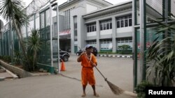 A worker sweeps at the gate of Cipinang prison in Jakarta, Jan. 17, 2016. Islamist cleric Aman Abdurrahman, who has led an Islamic State-affiliated militant network from the prison, was released early for Indonesia's Independence Day Thursday. He is back in jail and being questioned about his role in a January 2016 attack.