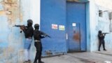 FILE—National Police stand guard outside the empty National Penitentiary after a small fire inside in downtown Port-au-Prince, Haiti, Haiti, March 14, 2024. 