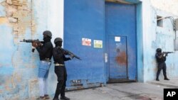 FILE—National Police stand guard outside the empty National Penitentiary after a small fire inside in downtown Port-au-Prince, Haiti, Haiti, March 14, 2024. 