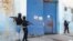 FILE—National Police stand guard outside the empty National Penitentiary after a small fire inside in downtown Port-au-Prince, Haiti, Haiti, March 14, 2024. 