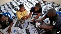 Congolese independent electoral commission (CENI) officials count the presidential ballots from more than 900 polling stations at a local results compilation center in Kinshasa, Congo, Jan. 4, 2019.
