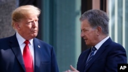 FILE - U.S. President Donald Trump, left, talks with Finnish President Sauli Niinisto in Helsinki, Finland, July 16, 2018.