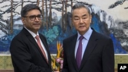 FILE - Chinese Foreign Minister Wang Yi, right, meets with India's Foreign Secretary Vikram Misri in Beijing, Jan. 27, 2025, in this image taken from a video. (Phoenix TV via APTN)