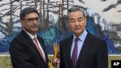 In this image taken from a video footage run by Phoenix TV, Chinese Foreign Minister Wang Yi, right, meets with India's Foreign Secretary Vikram Misri in Beijing, Jan. 27, 2025. (Phoenix TV via APTN)