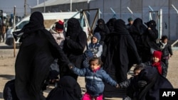 Women and children are seen in the Kurdish-run al-Hol camp which holds suspected relatives of Islamic State (IS) group fighters, in Hasakeh governorate in northeastern Syria, Jan. 28, 2021.