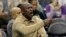 Charlotte Hornets owner Michael Jordan shouts to his team during the first half of an NBA basketball game against the Utah Jazz in Charlotte, N.C., Jan. 12, 2018.