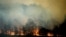 FILE - A bushfire burns in Bodalla, New South Wales, Australia, Jan. 25, 2020. 