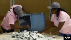 Polling officers verify ballots from ballot boxes arriving at a counting center in the Ledumang Senior Secondary school for the Gaborone North constituency, in Gaborone, Oct. 23, 2019.