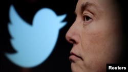 FILE - Twitter logo and a photo of Elon Musk are displayed through magnifier in this illustration taken October 27, 2022. 