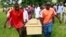 FILE - Pallbearers carry a coffin containing the remains of Francis Kamande killed when gunmen attacked the coastal Kenyan town of Mpeketoni, June 18, 2014. 