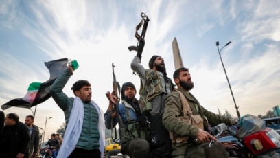 Syrian opposition fighters celebrate after the collapse of the Syrian government in Damascus, Syria, December 8, 2024.