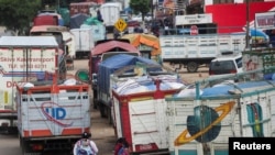 Trucks are parked near a barricade set up by supporters of Bolivia’s former President Evo Morales on one of the main highways, obstructing the supply of food and fuel in Mairana, Bolivia October 30, 2024.