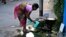 An Indian woman collects water leaking from a safety valve on an underground pipeline on World Water Day in Kolkata, India, March 22, 2017.