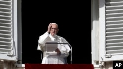 Pope Francis delivers a blessing during the Angelus noon prayer in St. Peter's Square, at the Vatican, Nov. 26, 2017. 