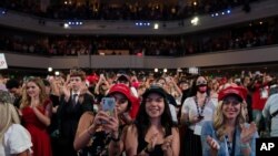 FILE - Supporters of President Donald Trump cheer as he arrives to a group of young Republicans at Dream City Church, in Phoenix, June 23, 2020.