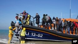 A group of people thought to be migrants are brought ashore at Dungeness in Kent, after being picked-up following a small boat incident in the Channel, England on Sept. 7, 2021.