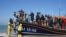 A group of people thought to be migrants are brought ashore at Dungeness in Kent, after being picked-up following a small boat incident in the Channel, England on Sept. 7, 2021.