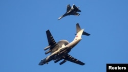 Russian Air Force Beriev A-50 early warning aircraft and Sukhoi Su-27 jet fighter fly in Kaliningrad, Russia April 25, 2020.