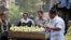 FILE - Egyptians buy fruits at a popular market in Cairo.