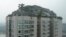 Privately built villa surrounded by imitation rocks atop a 26-story residential block, Beijing, Aug. 13, 2013.