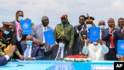 FILE - Sudan's transitional authorities and a rebel alliance sign a peace deal that aimed to end decades of civil wars, in a ceremony in Juba, South Sudan, Oct. 3, 2020.