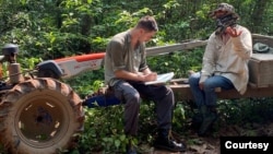 Gerald Flynn conducts an interview with community forest patrolers in Cambodia's Chhaeb-Preah Roka Wildlife Sanctuary while investigating illegal logging in 2023. (Chasing Deforestation/Mongabay photo)