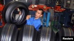 FILE - A worker removes a tire during production in a Goodyear factory in Bogor of Indonesia's West Java Province, Apr. 29, 2010.