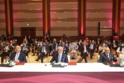 Abdullah Abdullah, center, chairman of Afghanistan's High Council for National Reconciliation, attends the opening session of peace talks between the Afghan government and the Taliban, in Doha, Qatar, Sept. 12, 2020.