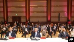 Abdullah Abdullah, center, chairman of Afghanistan's High Council for National Reconciliation, attends the opening session of peace talks between the Afghan government and the Taliban, in Doha, Qatar, Sept. 12, 2020.