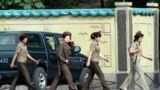 Female North Korean soldiers walk along the banks of the Yalu River near the town of Sinuiju, opposite the Chinese border city of Dandong.
