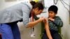 FILE - A boy gets an influenza vaccine injection at a health care clinic, in Boston, Massachusetts, Jan. 12, 2013.