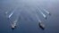 FILE - In this photo provided by U.S. Navy, the USS Ronald Reagan (CVN 76) and USS Nimitz (CVN 68) Carrier Strike Groups steam in formation, in the South China Sea, July 6, 2020.