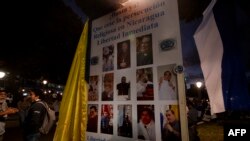 FILE — In this photo from January 6, 2024, exiled Nicaraguans in San Jose, Costa Rica protest the detention of priests, in front of the Metropolitan Cathedral.They allege that the government of Daniel Ortega fears the Catholic Church for defending "justice" and "human rights."