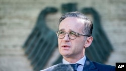 German Foreign Minister Heiko Maas addresses the media during a statement at the foreign ministry in Berlin, Germany, Wednesday, June 3, 2020. Germany’s government says it plans to lift a travel warning for European countries on June 15.