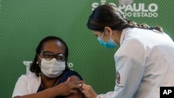 A nurse receives a COVID vaccine produced by China’s Sinovac Biotech, at the Hospital das Clinicas in Sao Paulo, Brazil, Jan. 17, 2021.