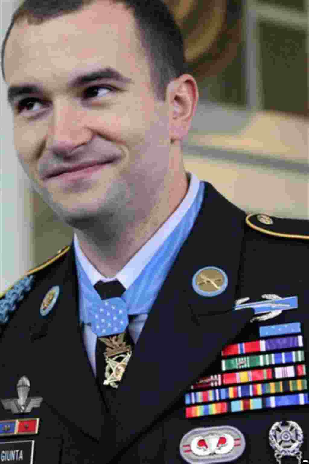 Staff Sgt. Salvatore Giunta smiles as he leaves the White House in Washington, Tuesday, Nov. 16, 2010, wearing the Medal of Honor presented to him by President Barack Obama. He is the first living person since the Vietnam War to receive the United States