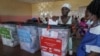 A voter casts her ballot during Liberia's presidential and legislative election in Monrovia on Oct. 10, 2023.