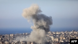 Smoke rises over buildings during an Israeli strike on Beirut's southern suburbs on November 14, 2024, amid the ongoing war between Israel and Hezbollah.